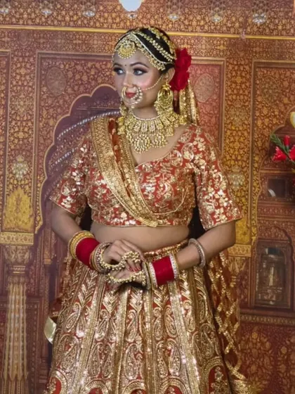 A stunning gold-on-gold look. This heavy, intricate gold-plated bridal set includes a choker, earrings, nath, and matha patti, all designed for a grand, royal wedding.
