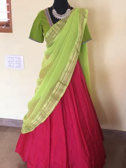 A simple and elegant half saree in pink and light green.