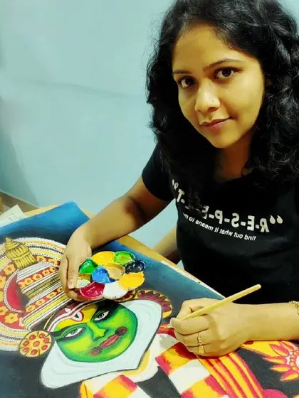 A close-up of me working on a Kathakali painting. The elaborate costumes and makeup are an iconic symbol of Kerala, and I take great care in capturing every detail with my brush and paints.