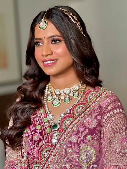Bringing bridal dreams to life with this stunning purple-toned lehenga. The makeup features soft pink and purple hues on the eyes, with a flawless, glowing base.