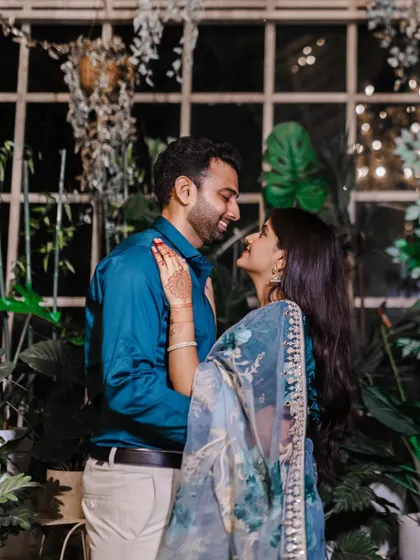 A beautiful shot from a pre wedding shoot in a lush, green setting. The couple's joy is palpable.