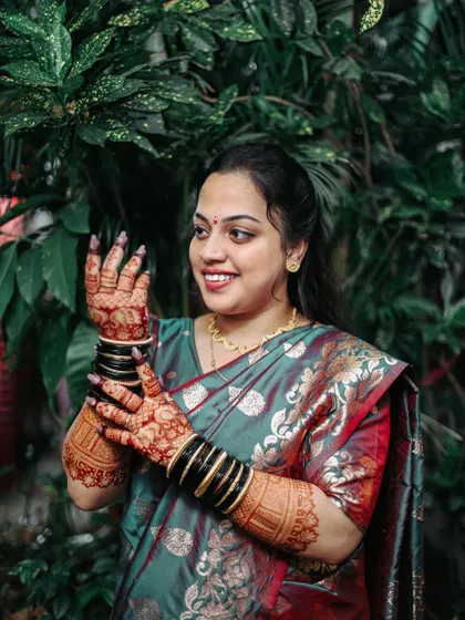 The bride showing off her intricate henna design during her Haldi ceremony.