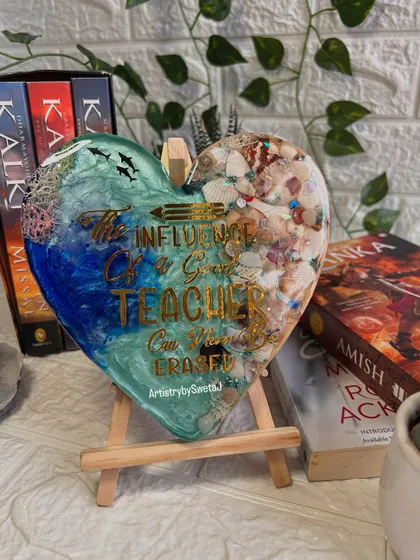 The teacher plaque displayed on an easel, surrounded by books. It's a tribute to the knowledge and inspiration that teachers provide.