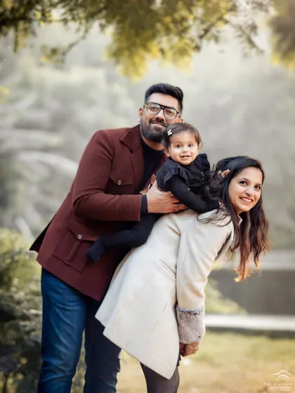 A playful and loving family portrait taken outdoors. We aim to capture the natural interactions and happiness that define your family.