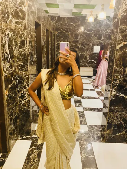 A mirror selfie capturing the complete outfit, from the sparkling blouse to the elegant drape of the saree. It’s all about feeling confident and loving your look.
