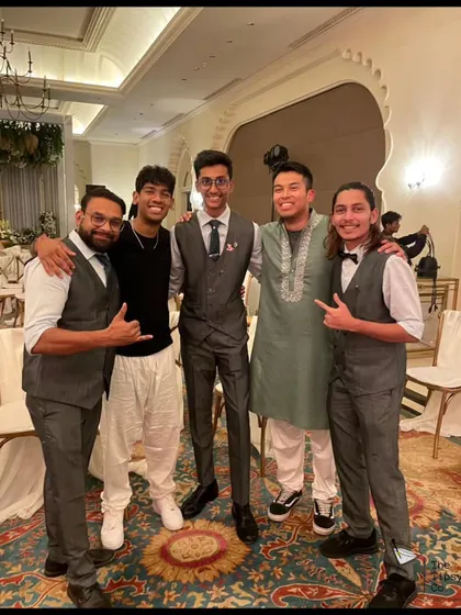 Our team posing with guests at a wedding reception. We aim to be more than just service providers; we become part of the celebration.