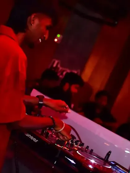 Another angle from the Anirudh fan party, showing the intense red lighting that set the mood for a high-energy rockstar tribute.