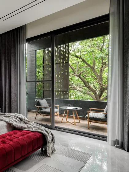 Detail shots from the son's bedroom, highlighting the custom woodwork on the feature wall, the sleek bedside table with integrated lighting, and the bold red velvet ottoman that adds a vibrant touch to the moody and masculine space.