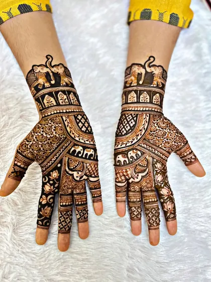 This design is perfect for a guest or a festival, featuring a prominent elephant motif. The patterns are dense on the hand but stop at the wrist, making it a statement piece that isn't as extensive as a full bridal design.