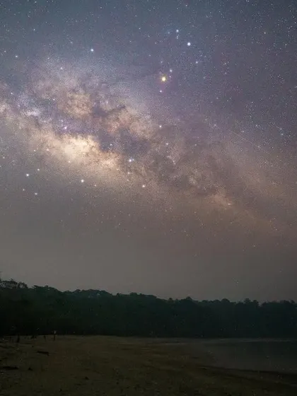 Putting things in perspective. Our home, the Milky Way, is a barred spiral galaxy about 100,000 light-years in diameter, containing our solar system and an estimated 100 billion stars.