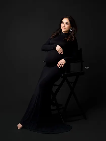 Oh so stunning. A classic seated portrait in a long black gown. The simplicity of the setup puts all the focus on the beautiful mamma-to-be.