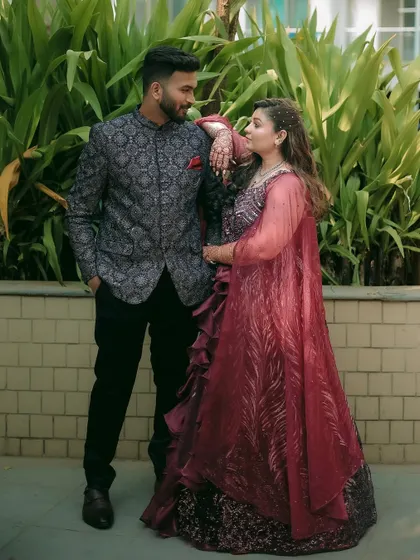 A stylish, posed portrait of the couple, showcasing their stunning engagement outfits.