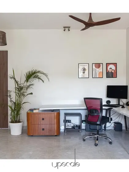 A home office designed to be a blank canvas for creativity and productivity. The space features clean lines, a neutral color palette, natural light, and touches of greenery to create a calm and inspiring work environment.