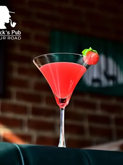 A classic cosmopolitan-style cocktail, presented simply to let the vibrant color and flavor shine. It's a popular choice for those who enjoy a timeless, fruity drink.