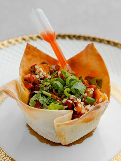 A creative fusion of Indian and Chinese flavours. Our Chinese Wonton Bhel Cup features crispy wonton strips tossed with fresh vegetables and tangy sauces, served in an edible cup with a pipette of extra dressing.