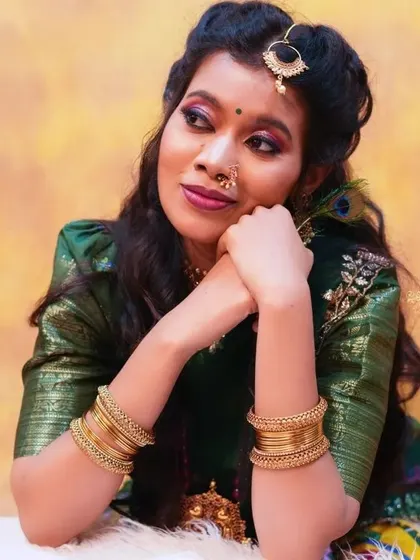 A thoughtful pose in the green half saree, showing its versatility for different moods in a photoshoot.