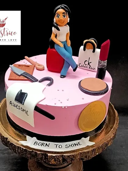 A personalized cake for a fabulous lady, decorated with her favourite things like shopping bags, makeup, and a custom figurine.