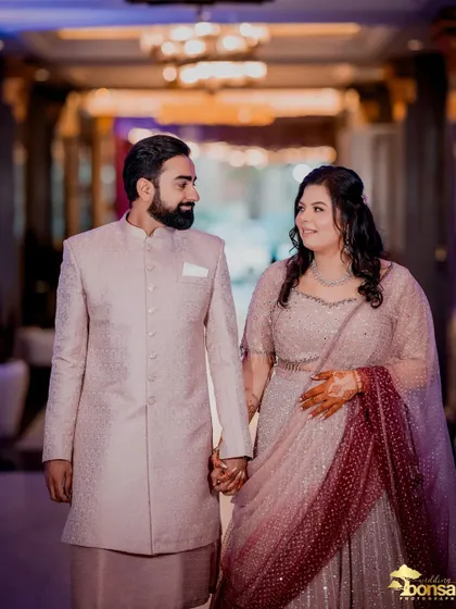 A candid walking shot of the couple, hand in hand, at their Roka ceremony.
