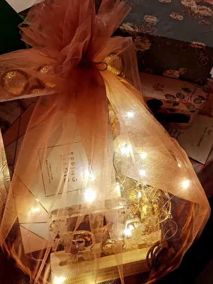 I also create custom gift hampers for other special occasions like Valentine's Day. This one is packed with chocolates, a notebook, and handmade resin gifts, all wrapped up with fairy lights.