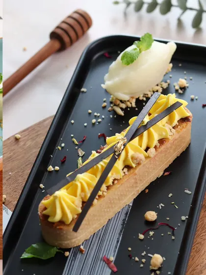 This dessert shot focuses on elegance and detail. The sharp lines of the pastry, the piped cream, and the delicate chocolate garnishes are all captured with precision to showcase the chef's artistry.