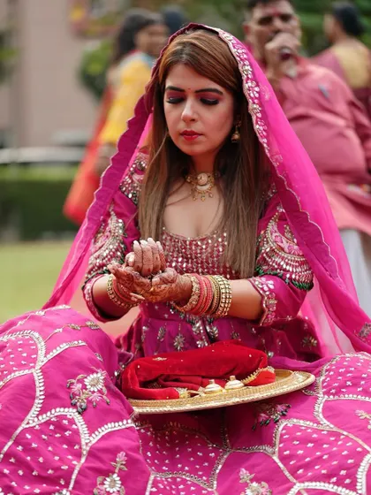 The client performing the puja, with her hands beautifully decorated with my henna art.