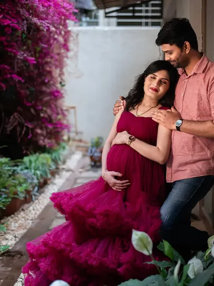 A tender embrace in a quiet garden corner. The flowing red gown adds a touch of drama and romance to this intimate couple's portrait.