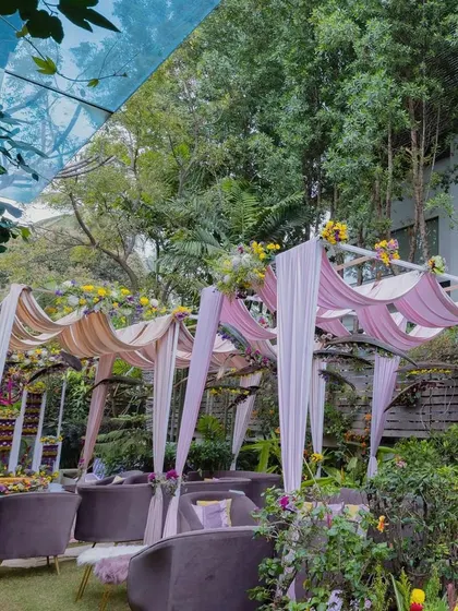 For a Haldi and Mehendi in a client's backyard, we used blush pink velvets for the canopies instead of conventional fabrics. The deep-colored furniture was chosen to break the monotony and add a touch of elegance.