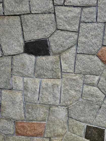 A close-up of random pattern wall cladding, showing how different colored stones can be mixed for a unique look.