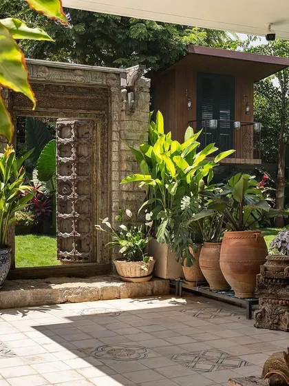 I believe in adding soul to a garden. This antique door, sourced and integrated into a modern landscape at Embassy Boulevard, acts as a stunning artistic focal point, blending history with contemporary design.