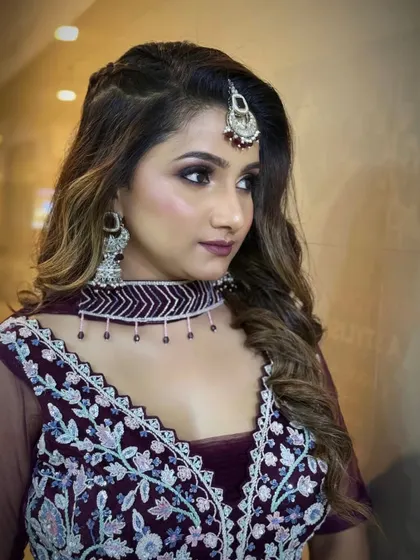 A side profile showcasing the hairstyle and the sharp contouring for this glamorous party look.