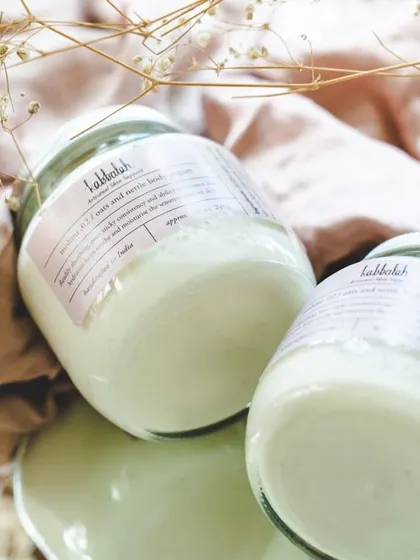 Jars of my 'Mohini' body yogurt, showcasing its creamy, pure white appearance. This lotion is packed with aloe vera juice and oat milk for deep hydration.