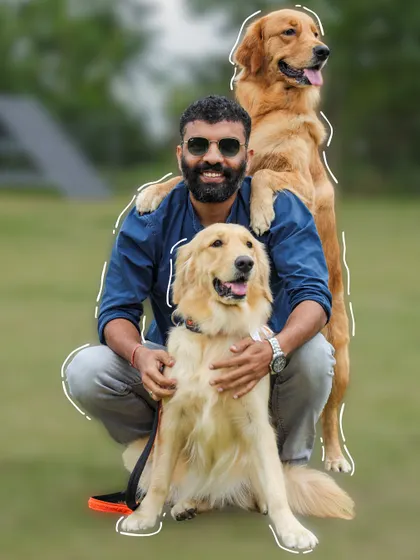 A happy dog dad with his two gorgeous Golden Retrievers. One is even standing on his shoulders for a better view.