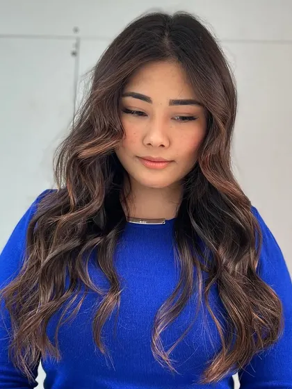 A front-facing view of the warm brown brunette color, showing how it flatters her skin tone and enhances her features.