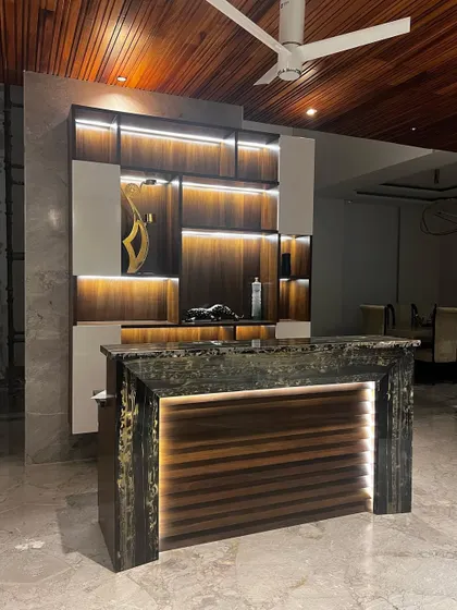 I designed this home bar to be a standout feature for entertaining. The unit combines rich wood textures with sleek white panels and integrated LED strip lighting to highlight the shelving. The bar counter itself is a statement piece, crafted from a unique, textured stone and underlit to create a dramatic and luxurious effect.
