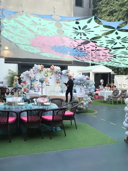 Here’s a wide view of our spacious outdoor lawn, all set up for a beautiful teddy bear themed party. You can see how I transform the space with grand balloon arches and comfortable seating for both kids and adults to enjoy the celebration.
