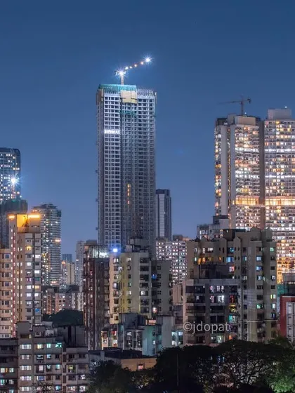 A mix of under-construction and completed skyscrapers defines this night view of the Mumbai skyline, highlighting the city's ongoing development.