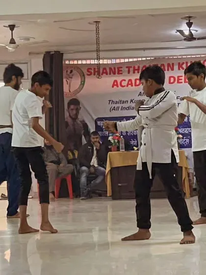 Young students engage in a three-person sparring drill. They learn to be aware of multiple opponents, a key aspect of street self-defense.
