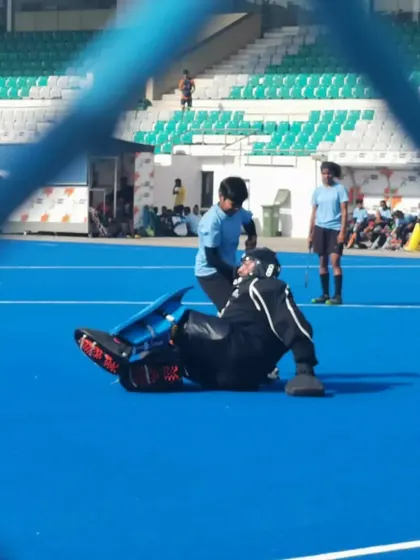 A unique view from behind the fence of my goalkeeper making a save. Every player on the field gives their all in these thrilling matches.