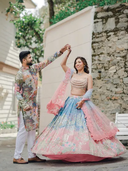 The groom twirls his bride during their outdoor Mehndi celebration. I love capturing these moments of movement and joy that show the couple's personality.