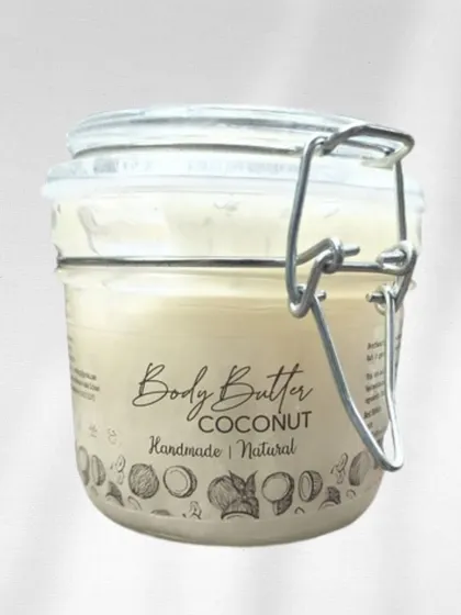 Our Coconut Body Butter, presented in its beautiful and reusable glass jar. We are committed to packaging that is both elegant and eco-friendly.