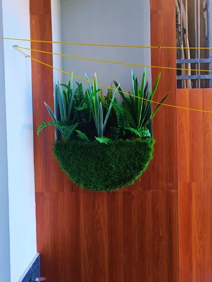 We also create custom wall planters with different types of foliage. This version features a mix of artificial snake plants and ferns for a purely green, textural look.