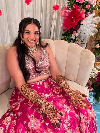 A radiant bride, Raksha, looking absolutely thrilled with her full bridal mehendi.