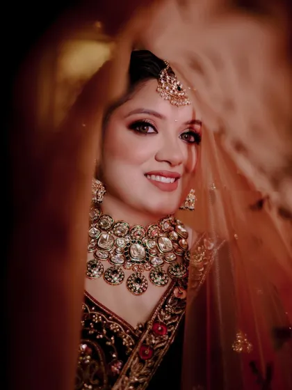A lovely "peek-a-boo" shot of the bride, Gunjan, through her veil.