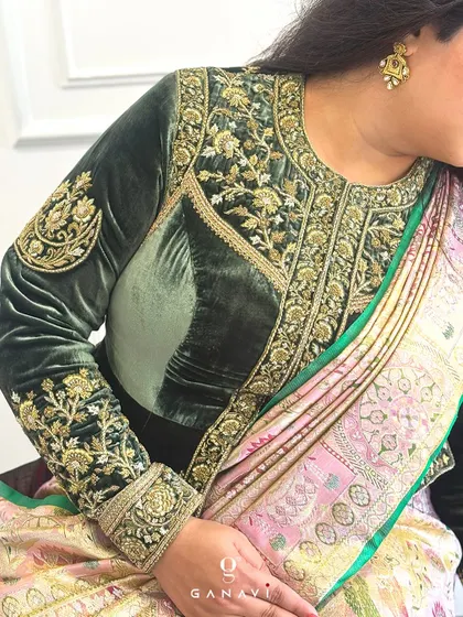 Another angle of the royal green velvet blouse, showing how it drapes beautifully. The intricate embroidery on the sleeves and neckline makes it a statement piece for any grand occasion.