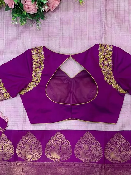 The back of the purple blouse, featuring a heart-shaped cutout and elegant embroidery on the shoulders.