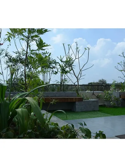 The terrace garden of a villa, designed with built-in seating and planters. These private open spaces provide residents with a direct connection to nature.