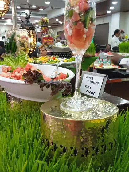 A large display of Watermelon Feta Cheese salad, served in both a large bowl and an oversized wine glass for dramatic effect.