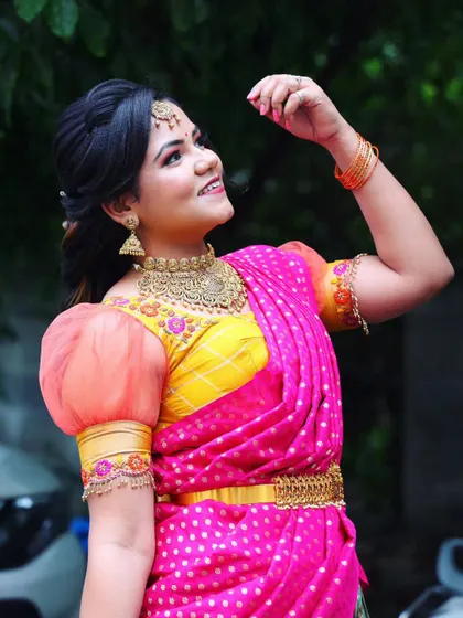 A joyful upward glance captures the essence of this look. The makeup is radiant and the colors of her outfit are so festive, making it perfect for any celebration.