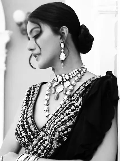 A black and white version of the cocktail look, which brings a timeless, classic feel. It emphasizes the intricate embroidery of the blouse and the silhouette of the polki jewelry.