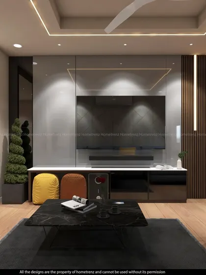 A direct view of the TV unit, showing the glossy finish and the contrast with the warm wood flooring. The colorful poufs add a playful touch to the otherwise neutral palette.